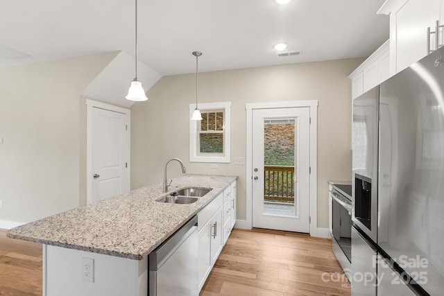 92 Wheeler Rd, Weaverville, NC 28787 - kitchen with stainless steel appliances, a sink, light wood-type flooring, white cabinets, and a peninsula