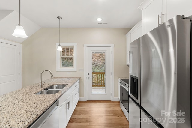 92 Wheeler Rd, Weaverville, NC 28787 - kitchen with appliances with stainless steel finishes, a sink, light wood-style floors, white cabinetry, and light stone counters