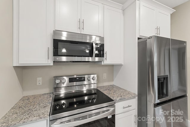 92 Wheeler Rd, Weaverville, NC 28787 - kitchen with stainless steel appliances, white cabinetry, and light stone countertops