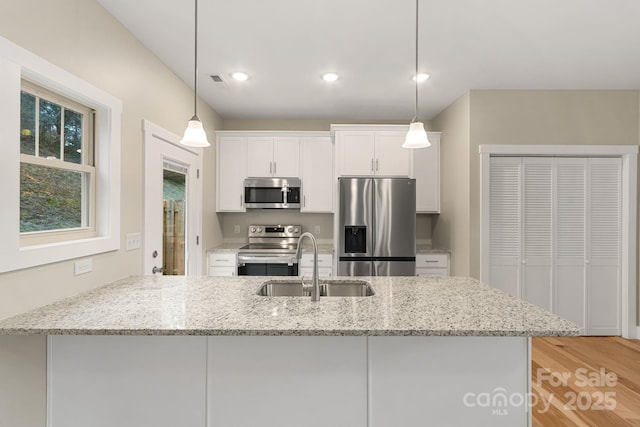 92 Wheeler Rd, Weaverville, NC 28787 - kitchen with stainless steel appliances, a sink, white cabinetry, light stone counters, and recessed lighting