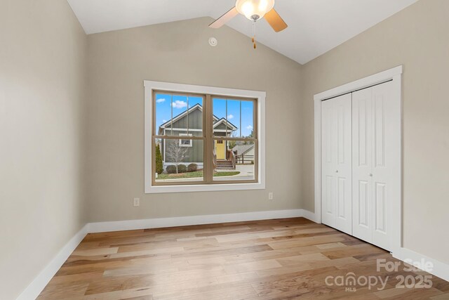 92 Wheeler Rd, Weaverville, NC 28787 - unfurnished bedroom with light wood-style floors, lofted ceiling, a closet, baseboards, and ceiling fan