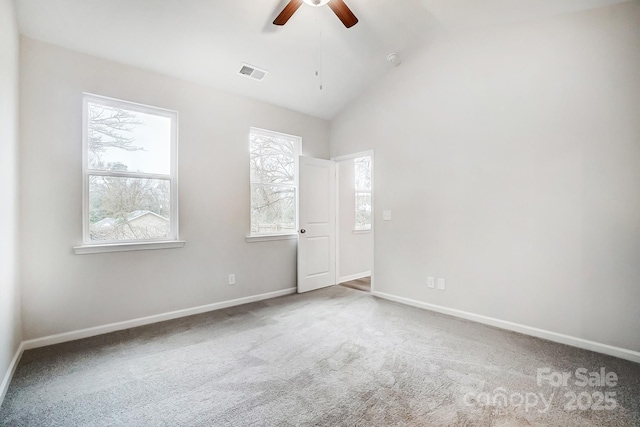 carpeted spare room featuring ceiling fan and lofted ceiling