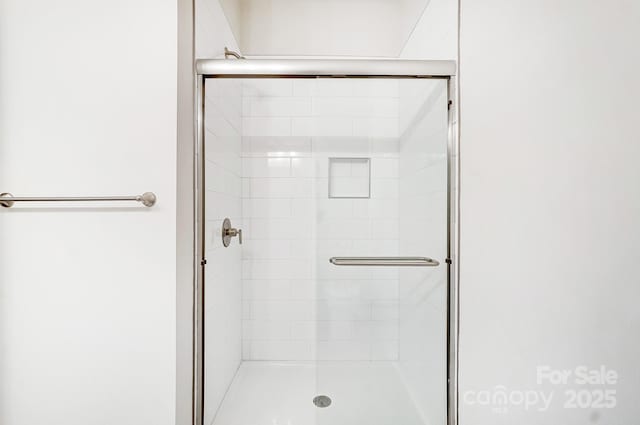 bathroom featuring a shower with shower door