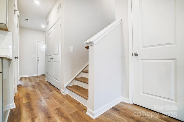 stairs with wood-type flooring