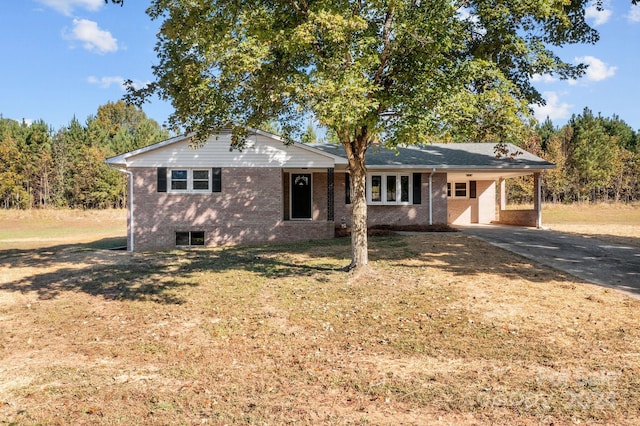 ranch-style house with a front yard and a carport