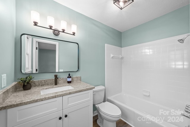 full bathroom with vanity, shower / washtub combination, a textured ceiling, and toilet