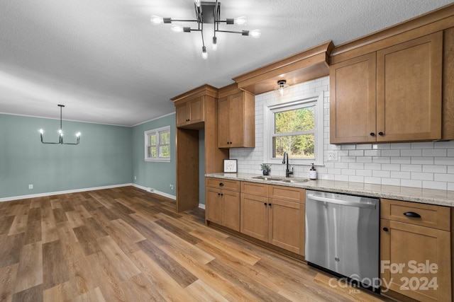 kitchen featuring light hardwood / wood-style flooring, a wealth of natural light, sink, and stainless steel dishwasher