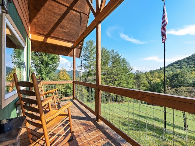 wooden terrace with a lawn