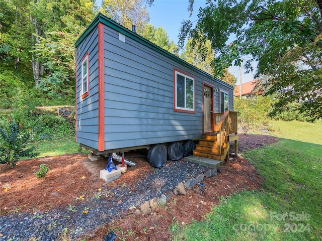 view of side of home featuring a yard