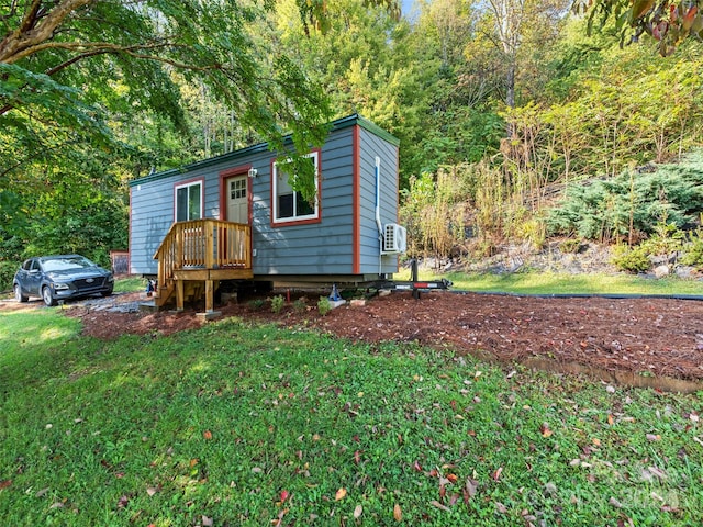 view of front of house with a front yard and cooling unit