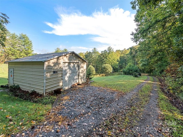 view of outbuilding featuring a lawn