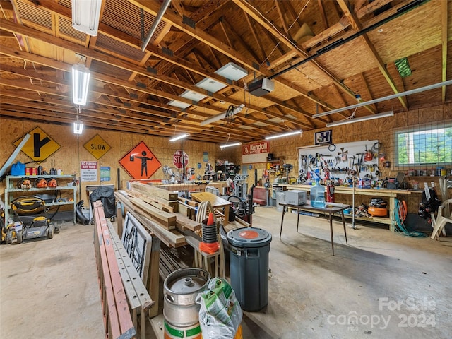 garage featuring a garage door opener and a workshop area