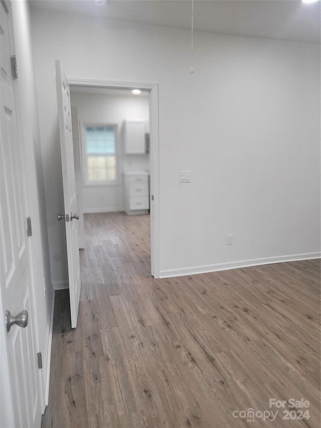 unfurnished room with hardwood / wood-style flooring