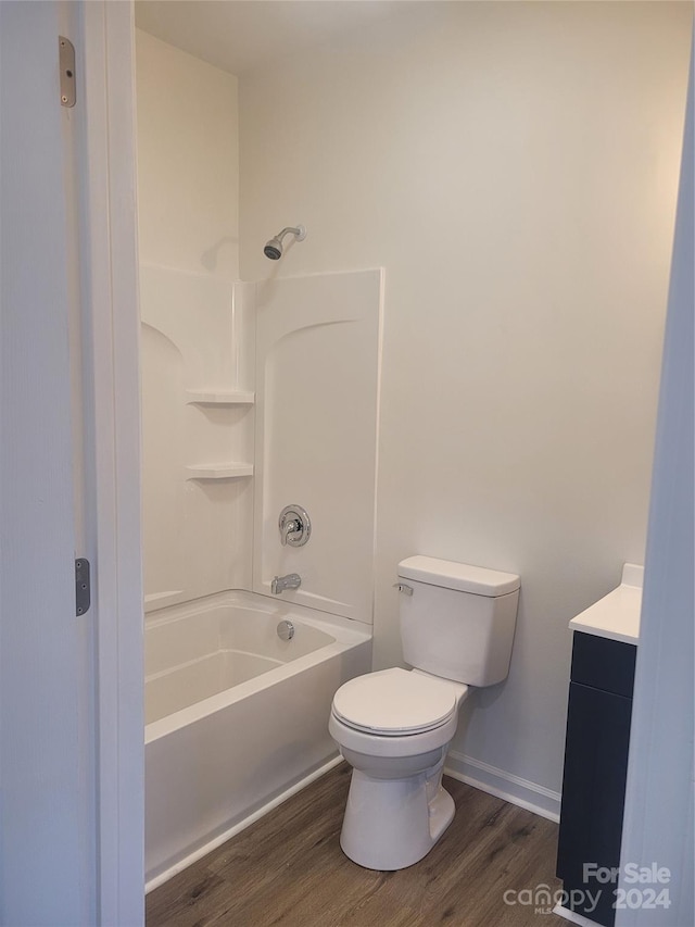 full bathroom with vanity, wood-type flooring, shower / bathtub combination, and toilet