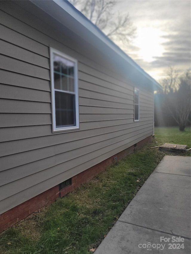 view of side of home with a patio