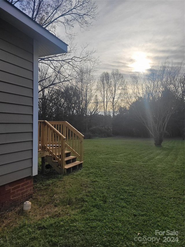 yard at dusk with a wooden deck