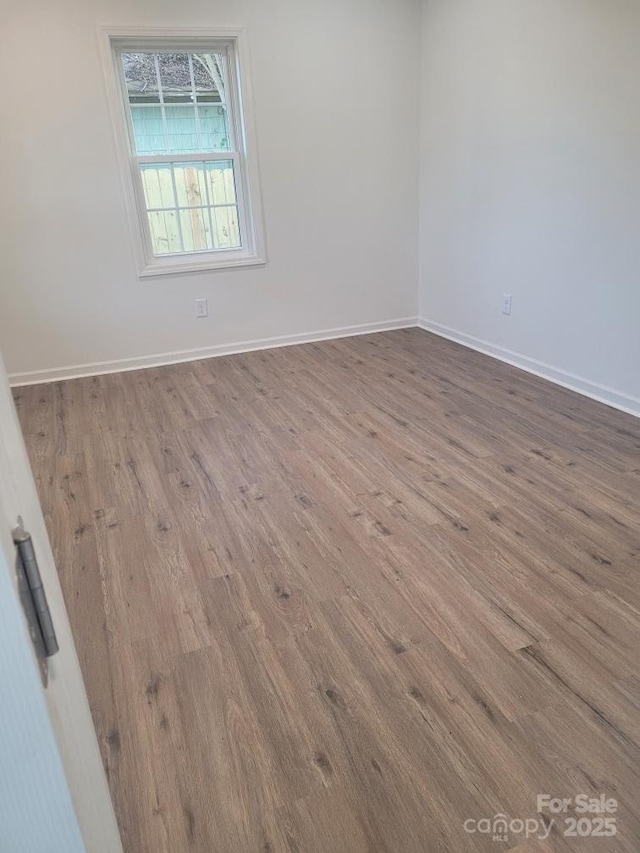 empty room with hardwood / wood-style flooring