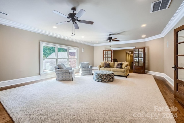 living room featuring ornamental molding, ceiling fan, and dark hardwood / wood-style flooring