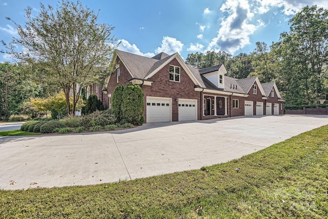 view of front of house featuring a garage and a front lawn