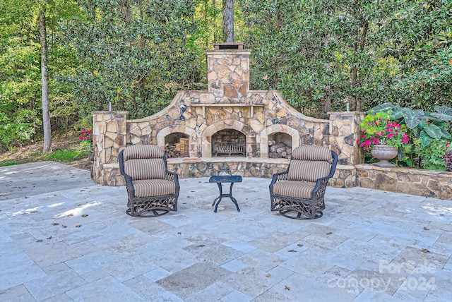 view of patio / terrace with an outdoor stone fireplace