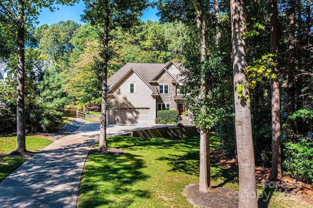 view of property with a garage and a front lawn