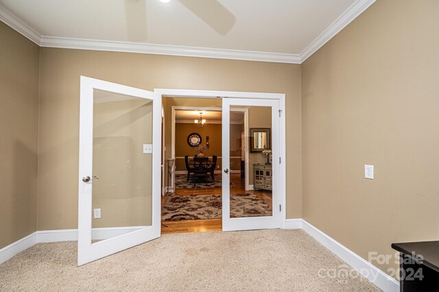 3905 Granite St, Terrell, NC 28682 - carpeted spare room featuring ornamental molding, baseboards, a chandelier, and french doors