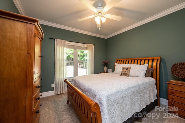 carpeted bedroom with ornamental molding and ceiling fan