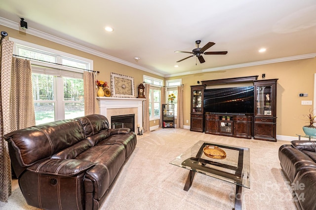 living room featuring ornamental molding, light carpet, and ceiling fan