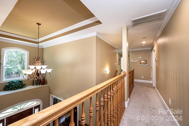 hallway with ornamental molding, a chandelier, and light carpet