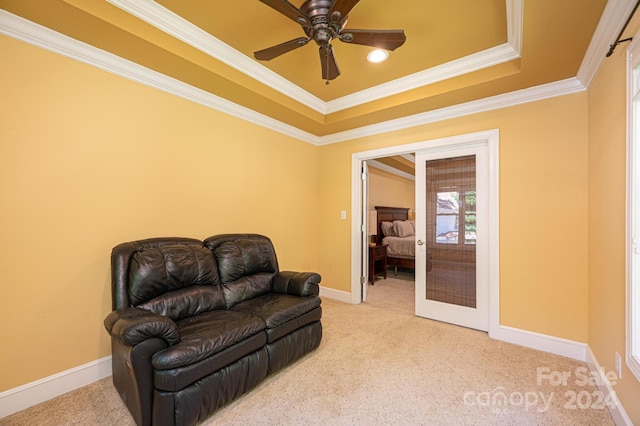 sitting room featuring french doors, crown molding, light colored carpet, and ceiling fan