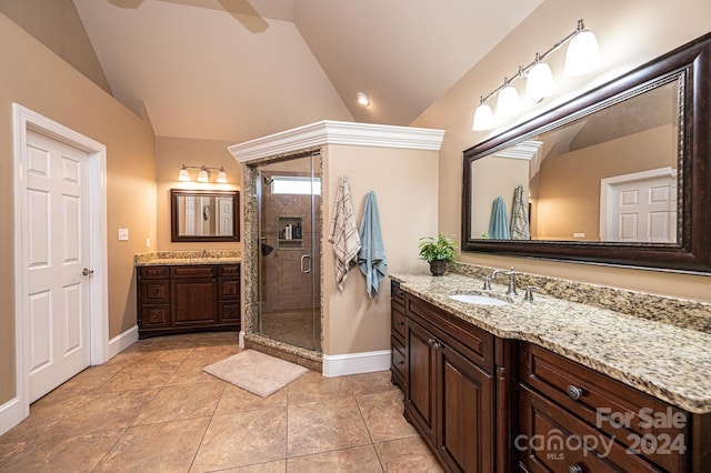 bathroom featuring vanity, tile patterned floors, walk in shower, and lofted ceiling