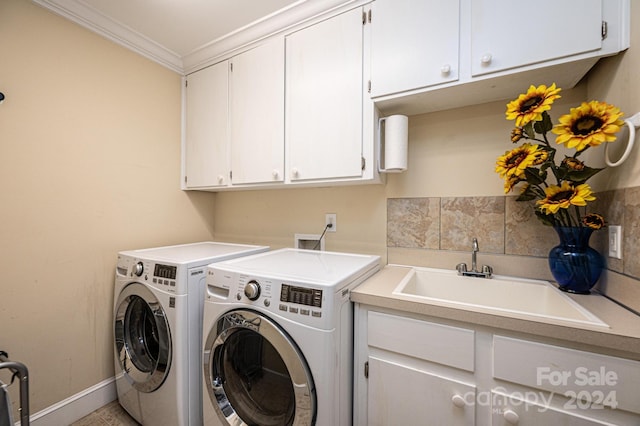 laundry area with sink, independent washer and dryer, crown molding, and cabinets