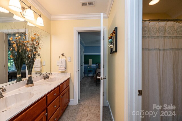 3905 Granite St, Terrell, NC 28682 - bathroom with crown molding, double vanity, tile patterned flooring, and baseboards