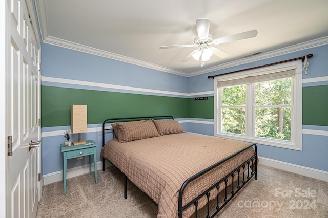 carpeted bedroom with ceiling fan and crown molding