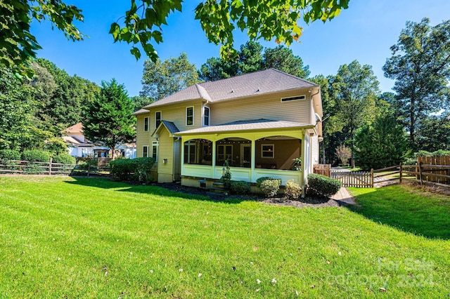 back of property featuring a yard