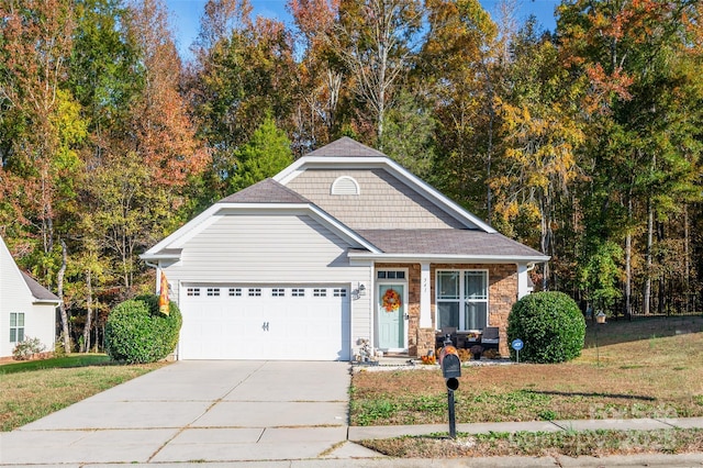 view of front of property featuring a garage and a front lawn