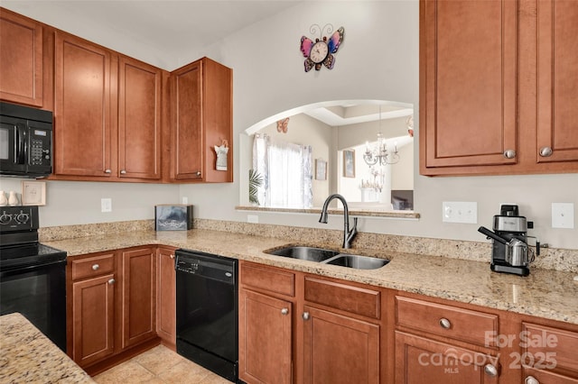 kitchen featuring light stone counters, sink, black appliances, light tile patterned floors, and a chandelier