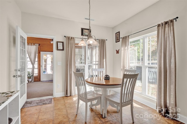 dining room with french doors and an inviting chandelier