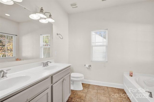 bathroom with vanity, toilet, and a bathtub