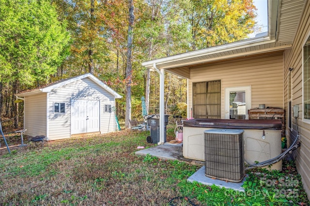 view of yard featuring a shed and cooling unit