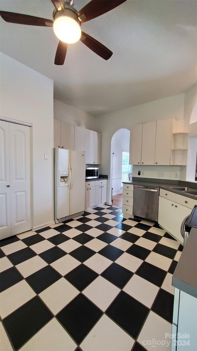 kitchen featuring white cabinets, stainless steel appliances, and ceiling fan