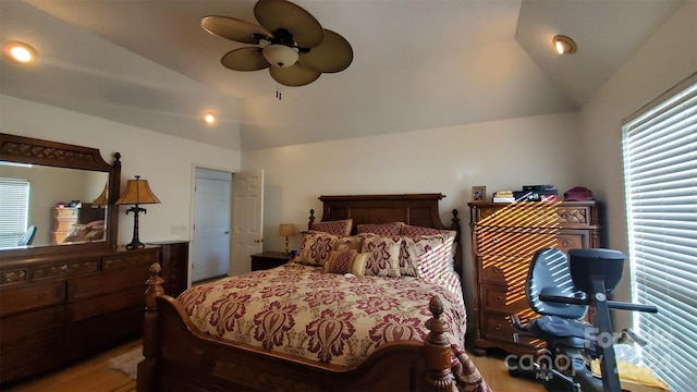 bedroom with ceiling fan, a closet, hardwood / wood-style floors, and vaulted ceiling