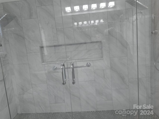 bathroom featuring a shower with shower door