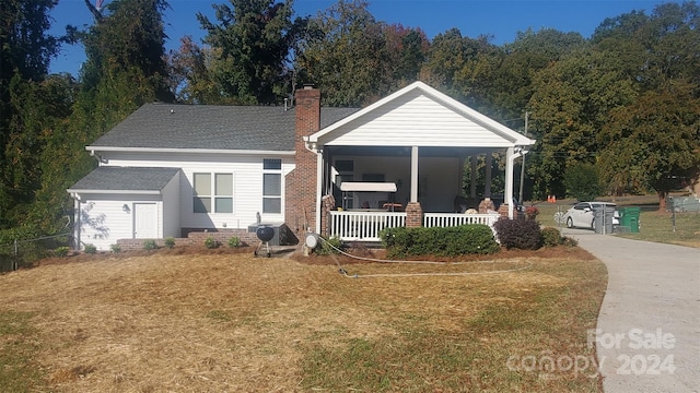 view of front of property with a porch and a front yard