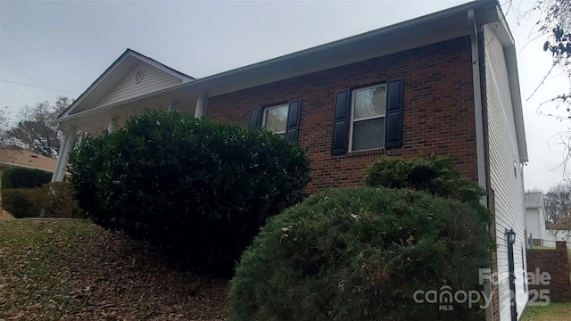 view of property exterior with brick siding