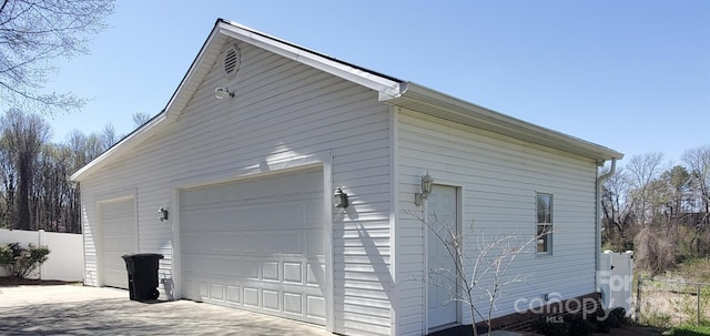 detached garage featuring fence