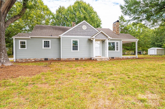 view of front of home featuring a front lawn and a shed