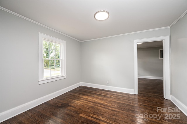 empty room featuring dark wood-type flooring and ornamental molding