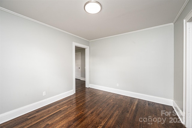 empty room with dark hardwood / wood-style floors and ornamental molding