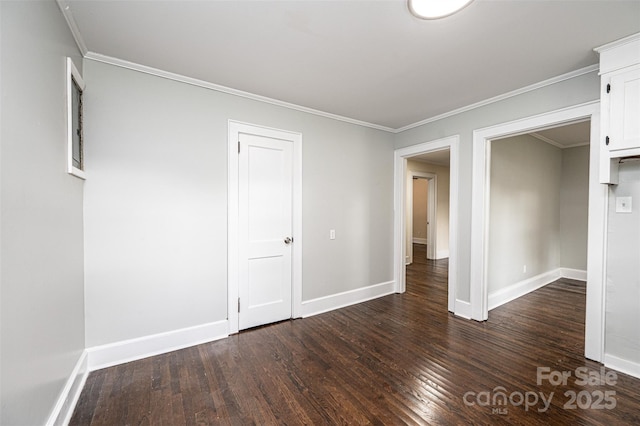 empty room with dark wood-type flooring and crown molding